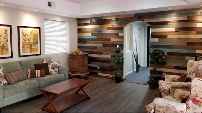 Another view of the smaller living room with the multicolor wood wall