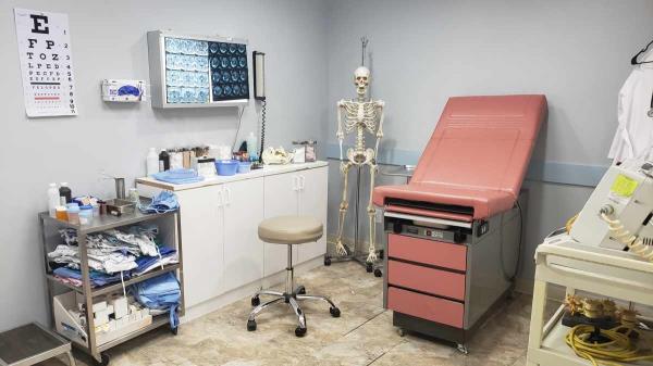 filming location hospital exam room with exam table, x-ray viewer, hospital props and hanging skeleton