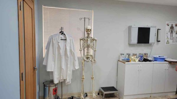 filming location hospital exam room with exam table, x-ray viewer, hospital props and hanging skeleton